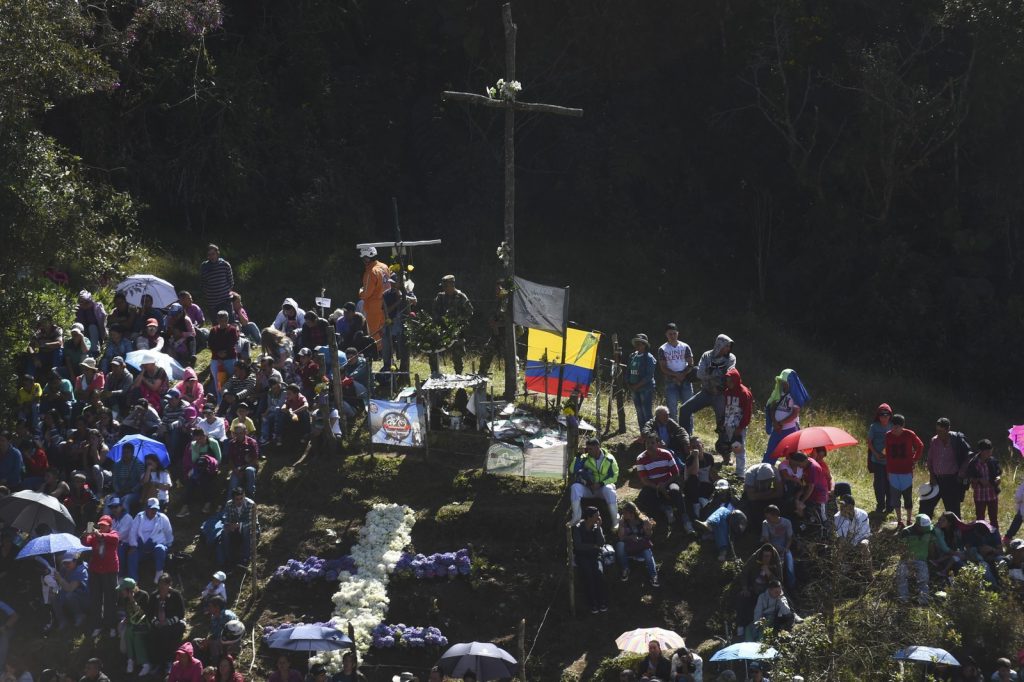 Dezenas de pessoas participaram de missa nesta terça-feira (28) no monte onde restou a fuselagem do avião, na Colômbia (Foto: Joaquin Sarmiento/AFP) 